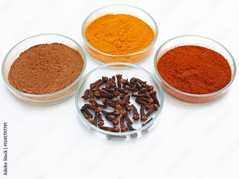 Various spices in a petri dish, white background Various spices in a petri dish, white background