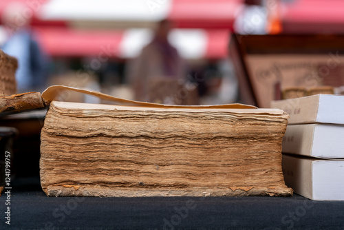 Old book on a market stall at the annual book fair in Dordrecht attracting avid readers and collectors with rare finds and popular titles in a charming historic setting. photo