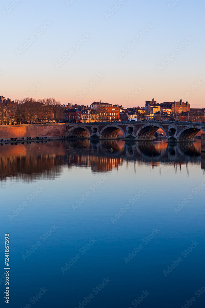 Fototapeta premium Pont Vieux Crossing the Garonne in Toulouse and Notre-Dame de la Dalbade Church at Sunset, Seen from the Opposite Bank