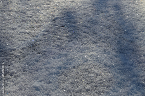 texture of snow cover in sunlight