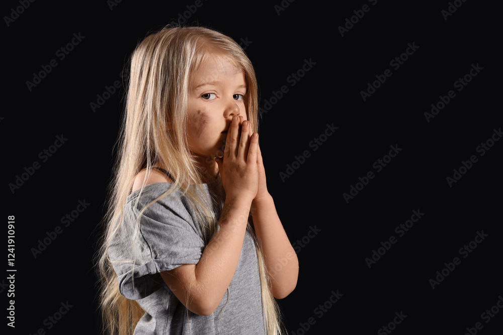 Homeless little girl against dark background Homeless little girl against dark background