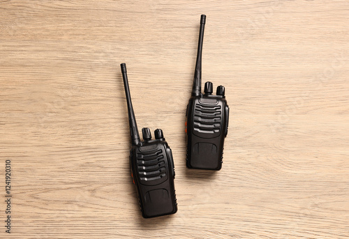 Walkie talkies on wooden table, top view photo