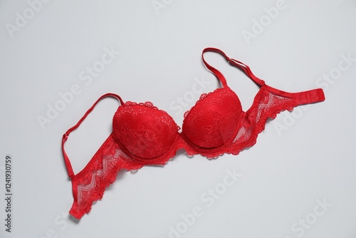 фотографія Beautiful red bra on light background, top view