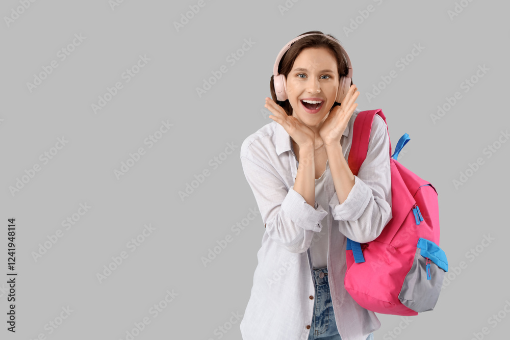 Surprised female student with backpack and headphones on white background Surprised female student with backpack and headphones on white background