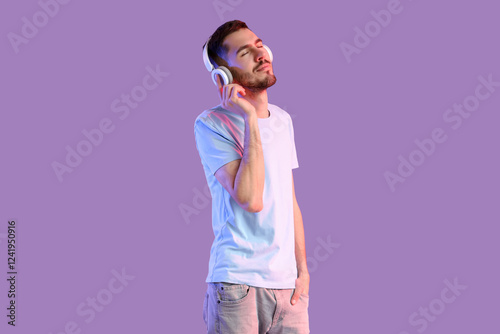 Young bearded man in headph...