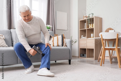 Mature man massaging his le...