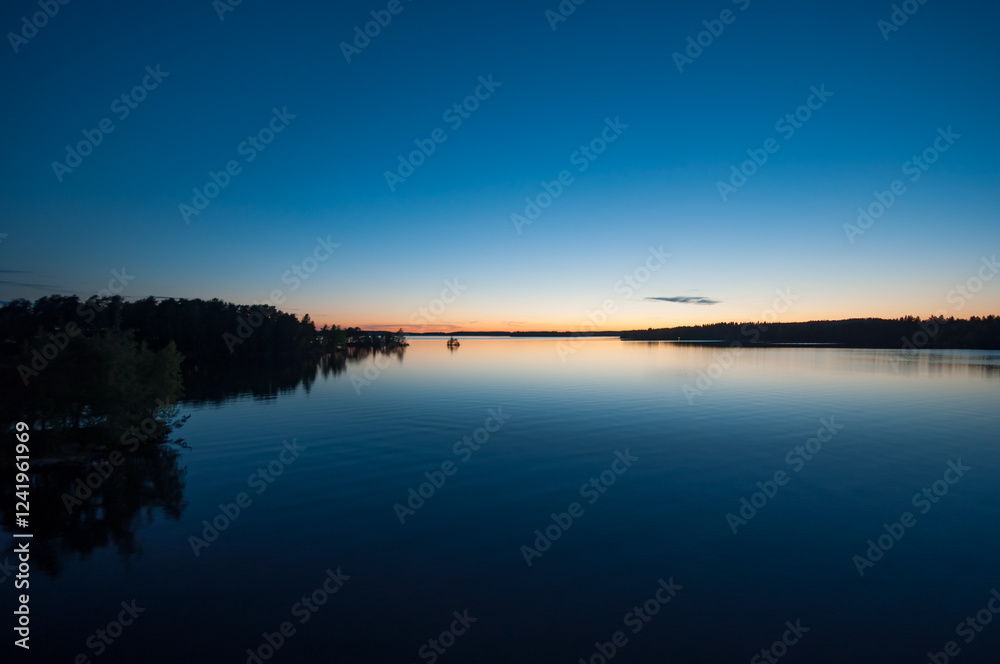 Early summer night by a calm lake in Finland Early summer night by a calm lake in Finland