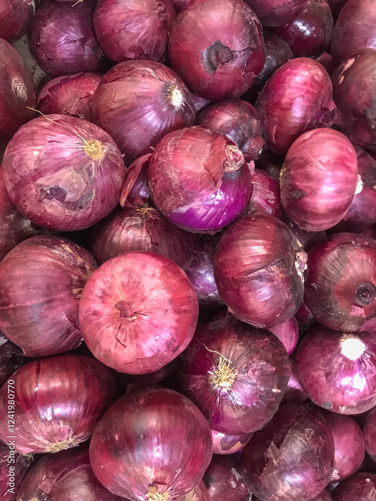 Close-up of fresh red onions with vibrant tones and shiny texture. Perfect for markets, recipes, and culinary content. Close-up of fresh red onions with vibrant tones and shiny texture. Perfect for markets, recipes, and culinary content.