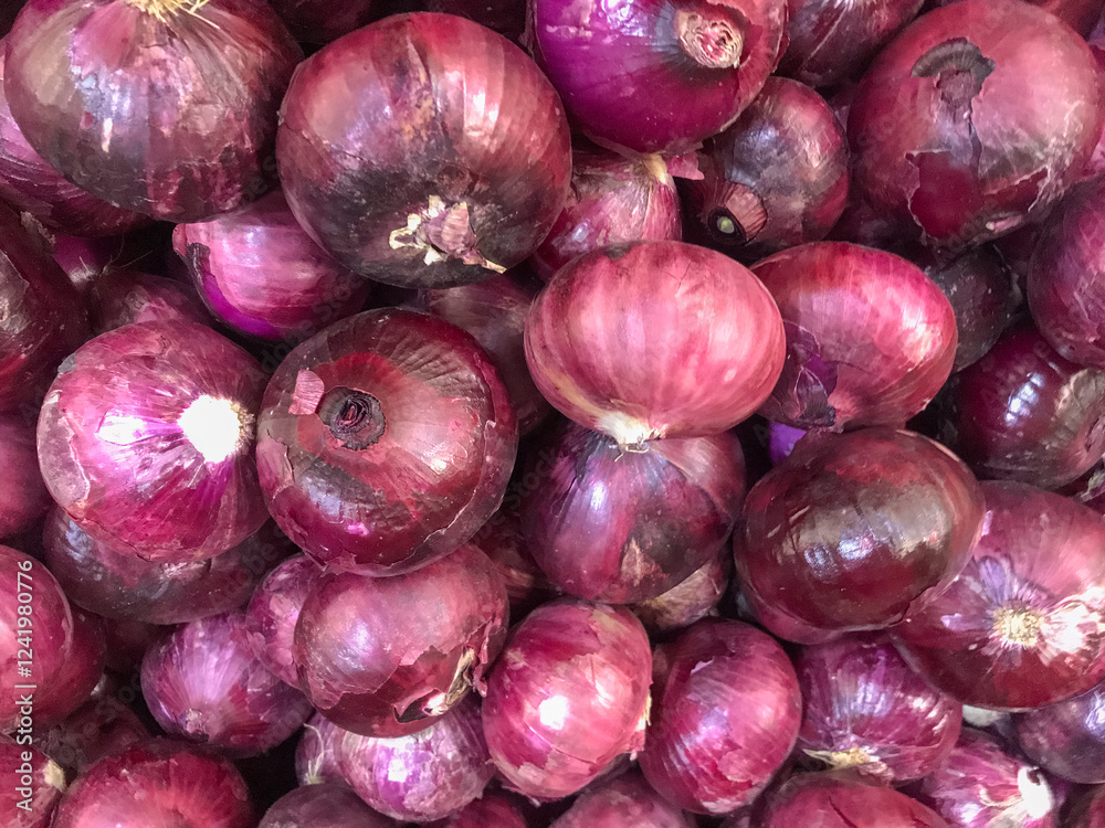 Close-up of fresh red onions with vibrant tones and shiny texture. Perfect for markets, recipes, and culinary content. Close-up of fresh red onions with vibrant tones and shiny texture. Perfect for markets, recipes, and culinary content.