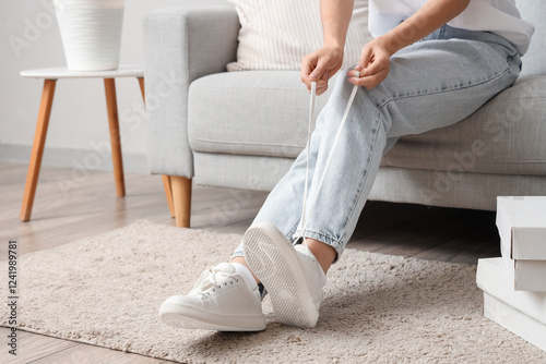 Woman in white sneakers sit...