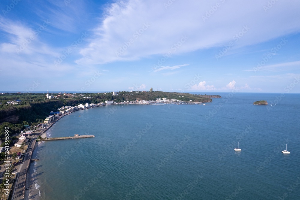 Peaceful coastal view of a quiet beach town with boats and clear skies on a sunny day Peaceful coastal view of a quiet beach town with boats and clear skies on a sunny day