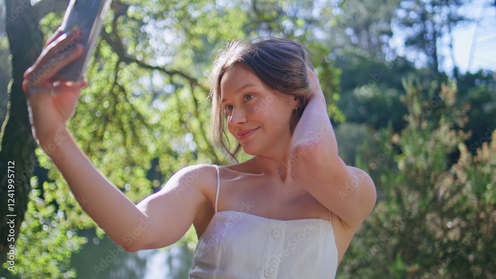 Flirting girl making selfie cellphone posing at lake shore in dress closeup Flirting girl making selfie cellphone posing at lake shore in dress closeup