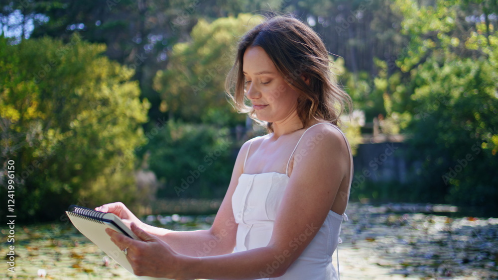 Dreamy girl sketching album relaxing at forest landscape closeup. Woman drawing Dreamy girl sketching album relaxing at forest landscape closeup. Woman drawing