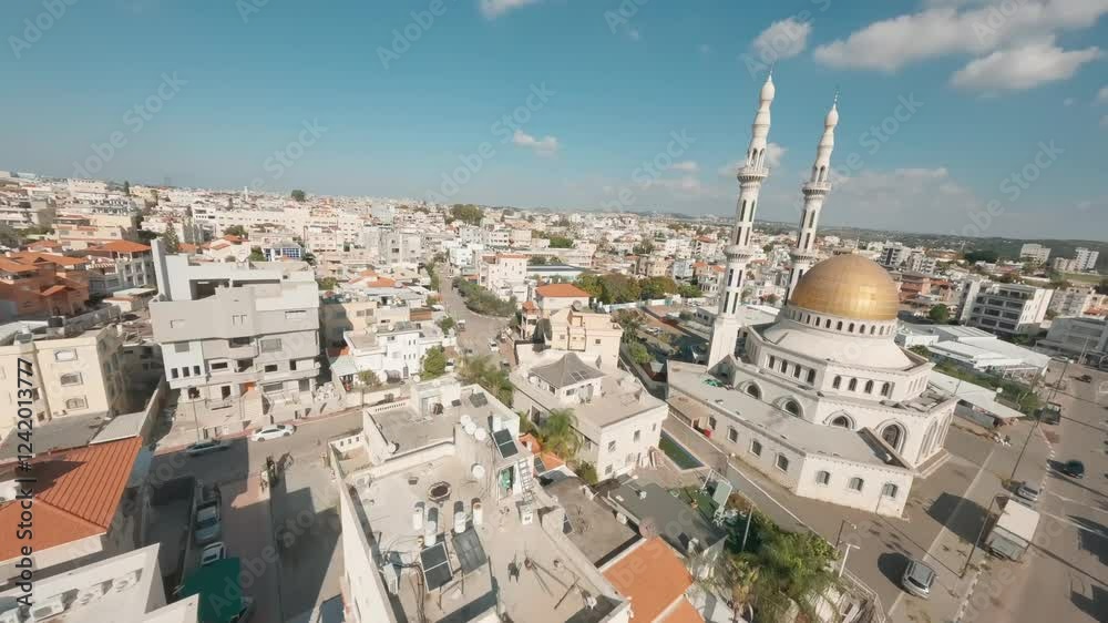 Aerial view of a city with residential buildings surrounding the Al Rawda Mosque. Aerial view of a city with residential buildings surrounding the Al Rawda Mosque.