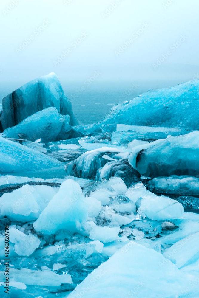 Floating iceberg of the Jokulsarlon Glacier Lagoon under heavy rain with the fog, Iceland