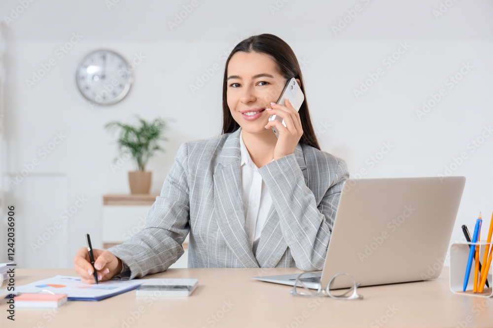 Young businesswoman working on report in office Young businesswoman working on report in office