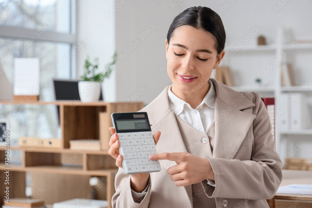 Young businesswoman with calculator working in office Young businesswoman with calculator working in office