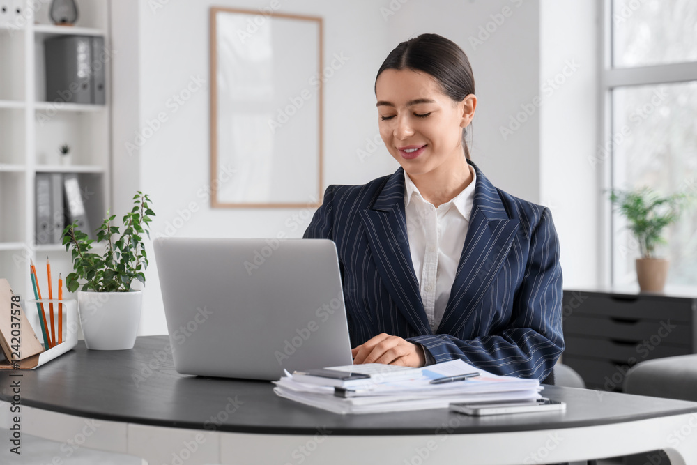Young businesswoman with laptop working on report at table in office Young businesswoman with laptop working on report at table in office