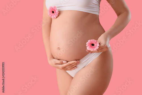 Wallpaper Mural Young pregnant woman in panties with gerbera flowers on pink background, closeup Torontodigital.ca