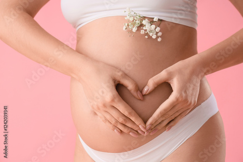 Wallpaper Mural Young pregnant woman in underwear with flowers making heart gesture on pink background, closeup Torontodigital.ca