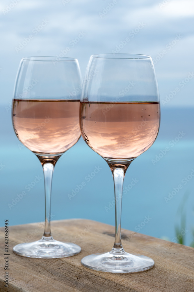 Summer time in Provence, two glasses of cold rose wine with blue sea view on background, French Riviera near Menton, south of France