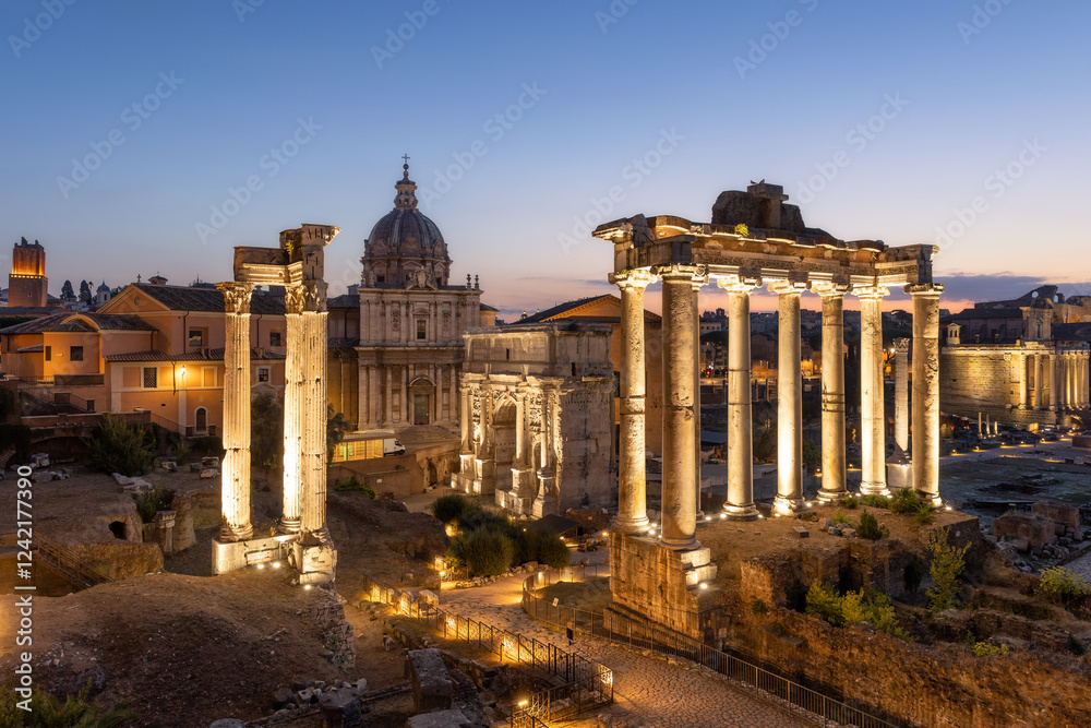 Naklejka premium Dusk at the Roman Forum and archaeological zone encompassing the ancient site lit up with lights. Rome, Italy
