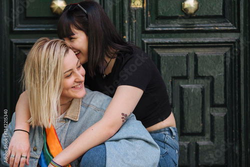 Lesbian couple sharing intimate moment, embracing love and affection photo