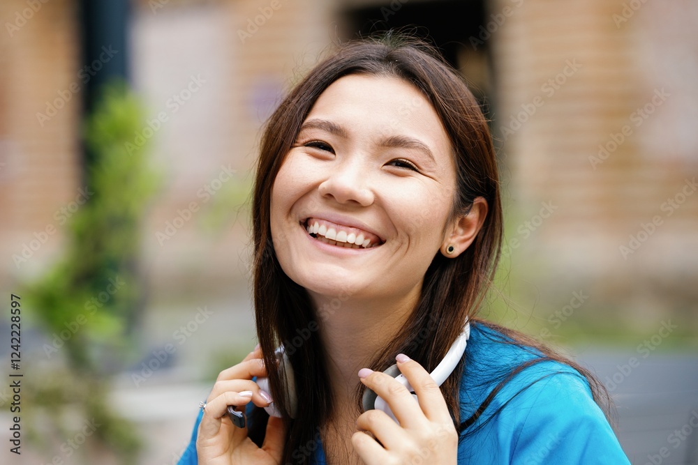 Portrait of joyful asian female nurse looking at camera outdoors Portrait of joyful asian female nurse looking at camera outdoors