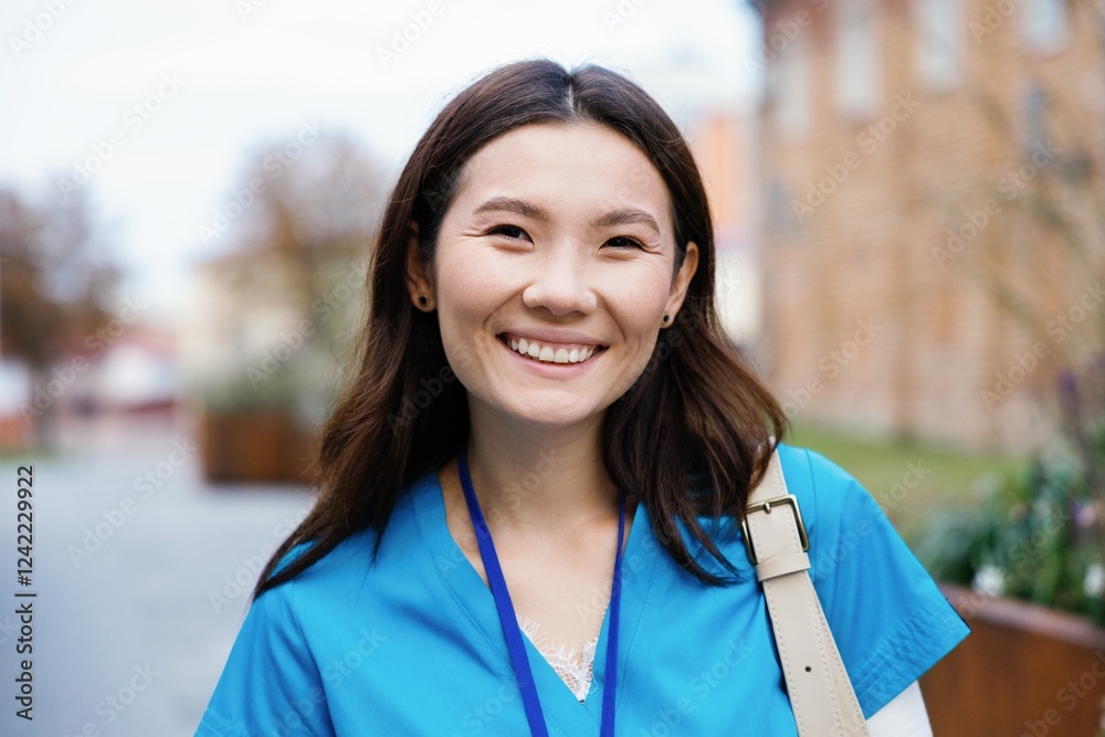 Portrait of partial young happy asian female nurse looking at camera Portrait of partial young happy asian female nurse looking at camera
