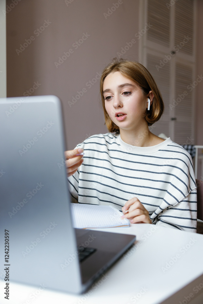 Female school student talking during having online lesson on laptop Female school student talking during having online lesson on laptop