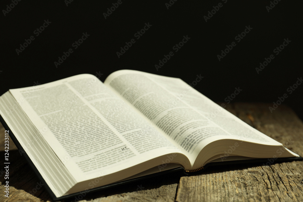 Open Holy Bible in English language on wooden table Open Holy Bible in English language on wooden table