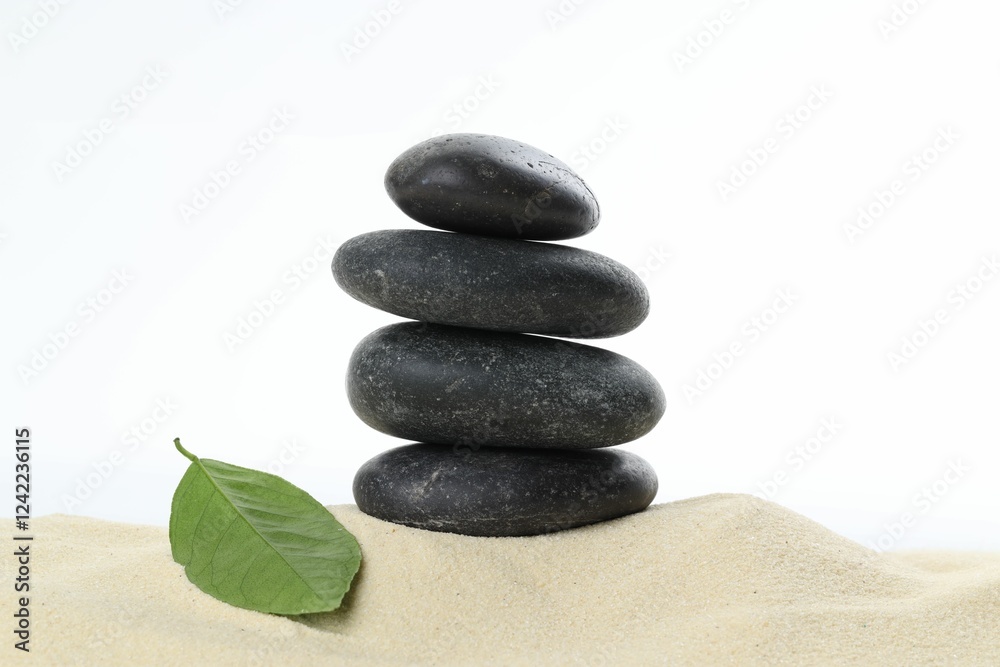 Stack of rocks on sand against white background. Harmony and life balance Stack of rocks on sand against white background. Harmony and life balance