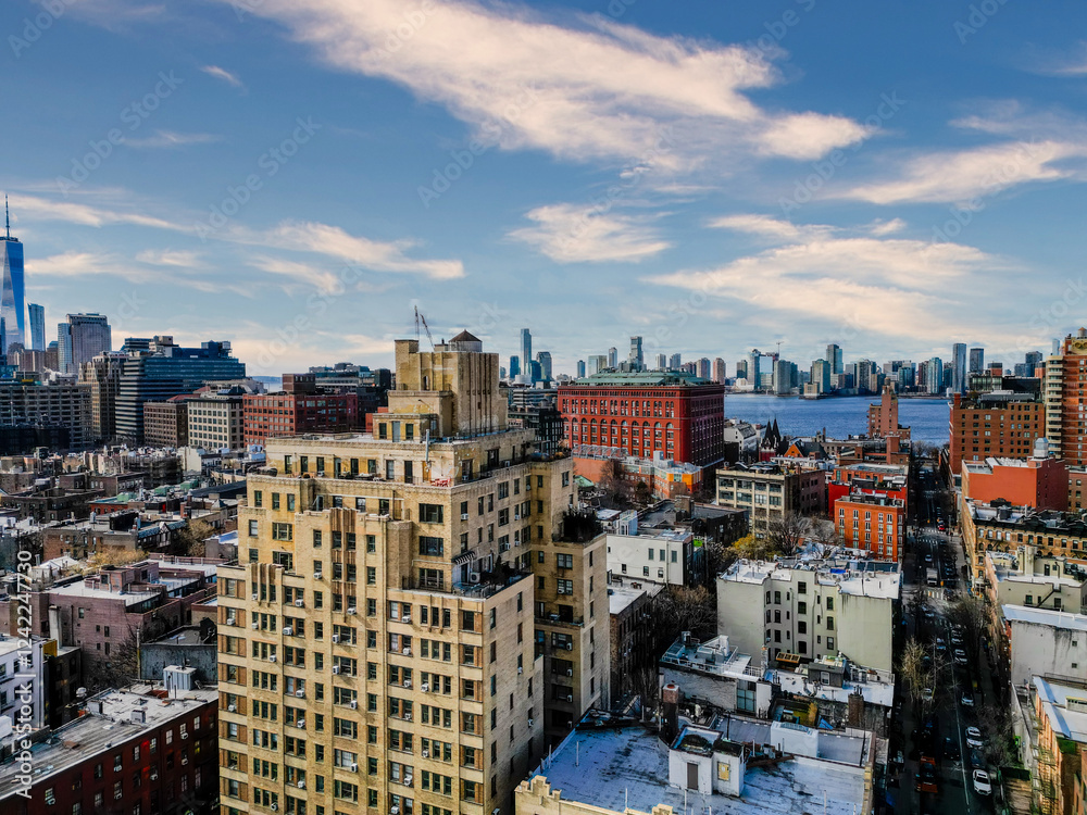 Fototapeta premium Cityscape view of buildings and skyline under a partly cloudy sky.