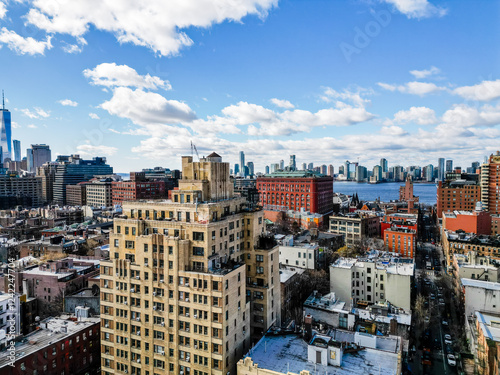 Urban cityscape view with a mix of building styles under a partly cloudy sky.