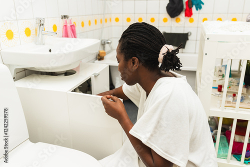 Mother Doing Chores in the Toilet of Apartment