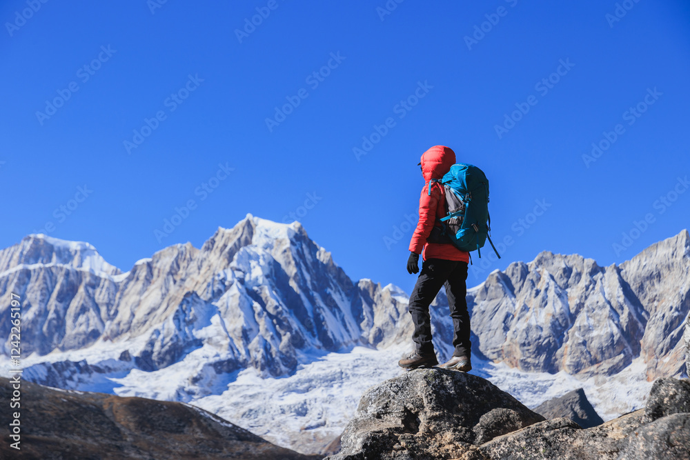 Successful woman hiker on high altitude mountain top Successful woman hiker on high altitude mountain top