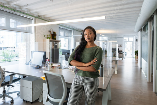 Confident businesswoman posing with crossed arms