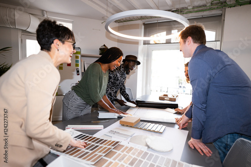 Architects choosing wood and tile samples, working together photo