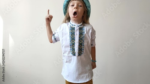 A little boy dressed in Ukrainian traditional clothes, vyshyvanka. Smiling child looking at the camera. Portrait of a little kid smiling child looking at the camera. Children's smile. Close-up face