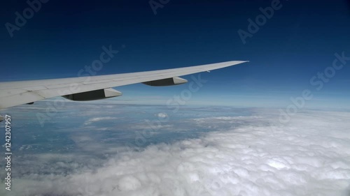 Tapered Airplane Wing Flying High Altitude Above Clouds Passenger View