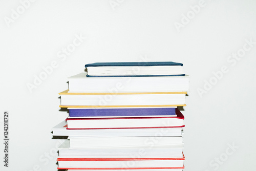 Stack/pile of books in office workplace with hard direct flashlight photo