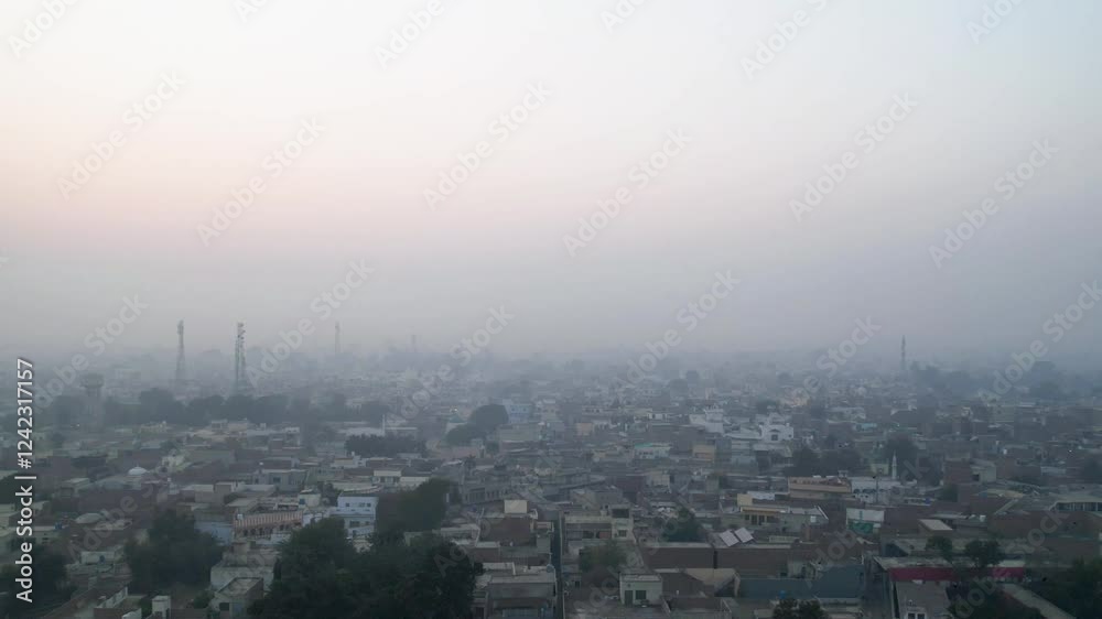Timelapse of Basirpur, Okara, Pakistan, showing the urban skyline with rooftops and communication towers at dawn Timelapse of Basirpur, Okara, Pakistan, showing the urban skyline with rooftops and communication towers at dawn