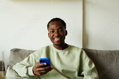 Happy man sitting alone on the sofa photo