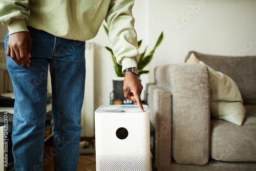 Man turns on the air purifier