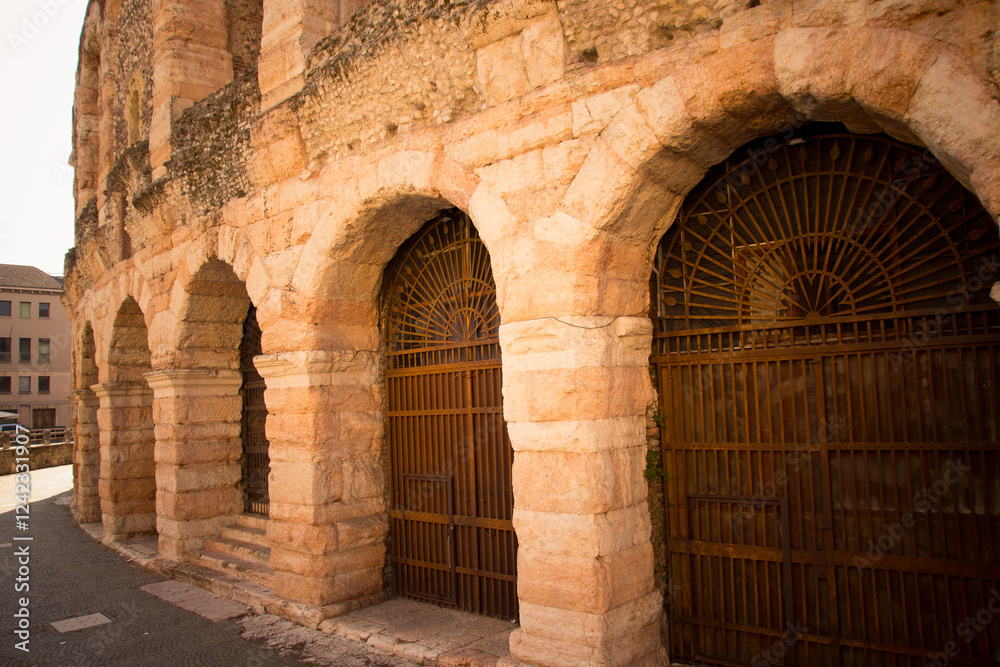 Fototapeta premium Close-up of the ancient stone archways and iron gates of the Verona Arena, a well-preserved Roman amphitheater in Verona, Italy.