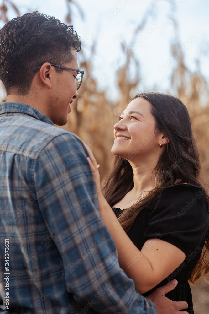 Fototapeta premium Young couple in the countryside looking into each other's eyes