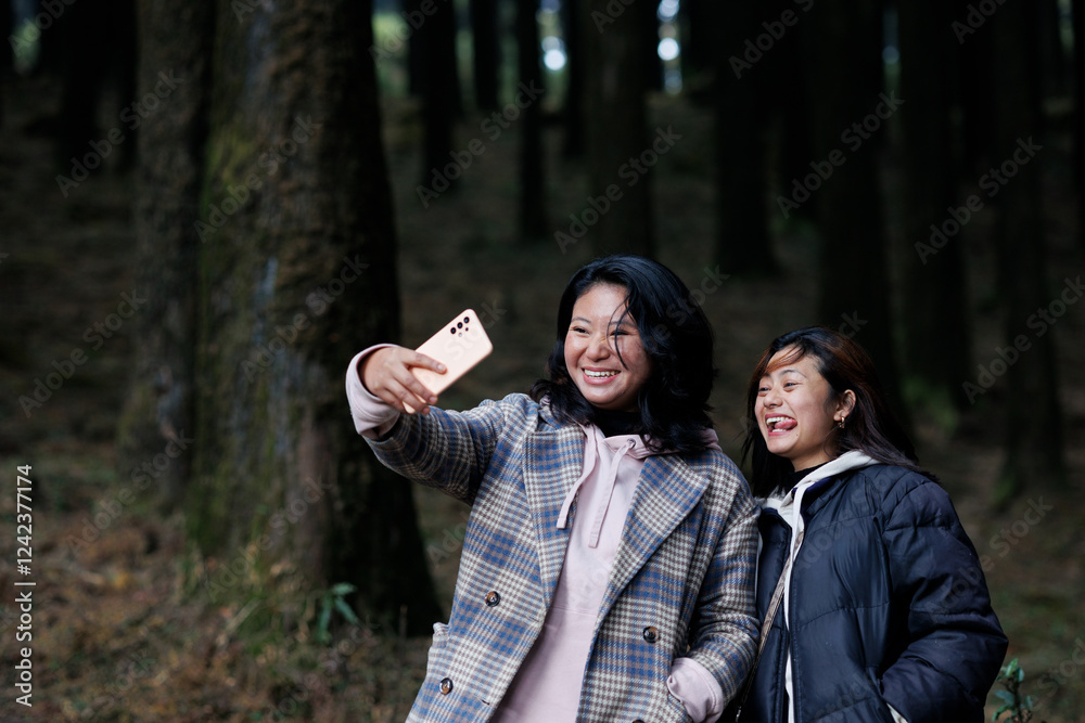 Happy young women taking selfie outdoors having fun Happy young women taking selfie outdoors having fun
