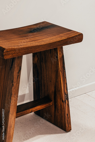 Wooden stool with rich grain in minimalist setting photo