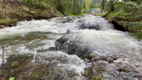 Fast mountain river with pure clear water running among large stones