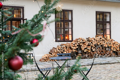 Cozy Christmas Atmosphere With Firewood Stacked in Winter Setting photo